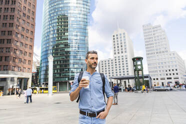 Man in the city holding a cup of coffee, Berlin, Germany - WPEF02063