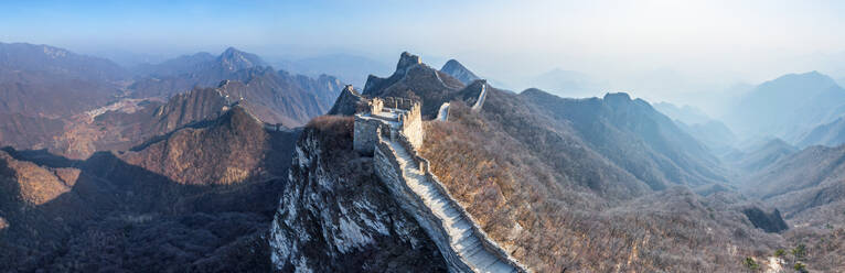 Aerial view of the Great Wall of China crossing mountain chain. - AAEF04758
