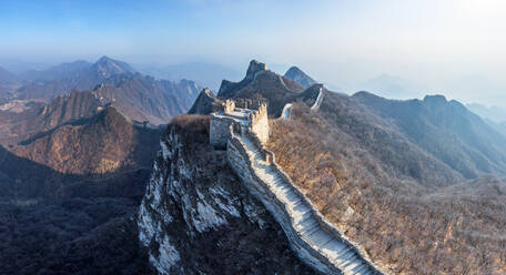 Aerial view of the Great Wall of China crossing mountain chain. - AAEF04759