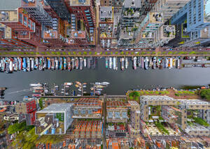 Aerial view above of boats anchored at Amsterdam canal, Netherlands. - AAEF04964