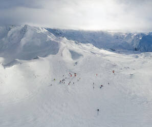 Luftaufnahme von Menschen beim Skifahren in Courchevel Alps, Frankreich. - AAEF05570