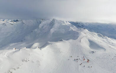 Luftaufnahme von Menschen beim Skifahren in Courchevel Alps, Frankreich. - AAEF05571