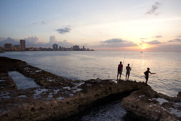 Fishing along the Malecon at sunset in Havana, Cuba, West Indies, Caribbean, Central America - RHPLF12406