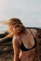 Swimmer by seaside enjoying wind in hair - ISF22521