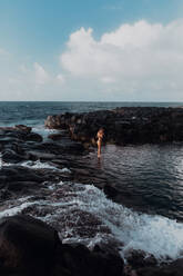 Swimmer enjoying enclosed sea pool, Princeville, Hawaii, US - ISF22601