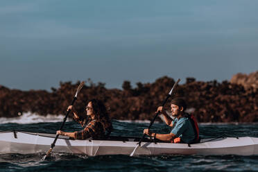 Friends kayaking in sea, Big Sur, California, United States - ISF22655