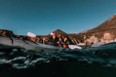 Friends kayaking in sea, Big Sur, California, United States - ISF22659