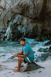 Man relaxing on beach, Big Sur, California, United States - ISF22667