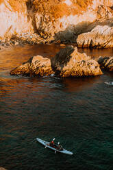 Friends kayaking in sea, Big Sur, California, United States - ISF22675