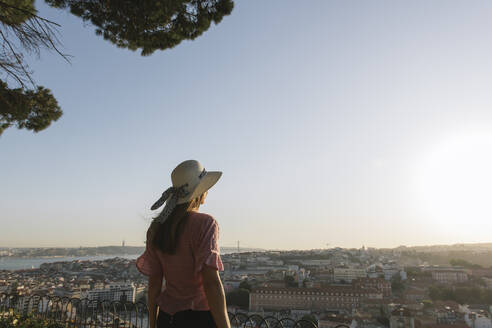 Rear view of woman in front of the city panorama, Lisbon, Portugal - AHSF01003