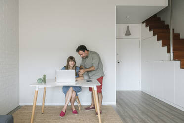 Couple with credit card and laptop in modern flat - AHSF01041