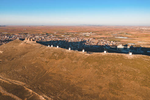 Spain, Province of Toledo, Consuegra, Row of old windmills standing on top of brown hill - WPEF02107