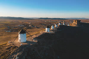Spain, Province of Toledo, Consuegra, Row of old windmills standing on top of brown hill - WPEF02108