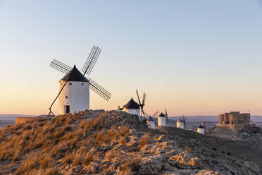 Spain, Province of Toledo, Consuegra, Row of old windmills standing on top of hill - WPEF02109