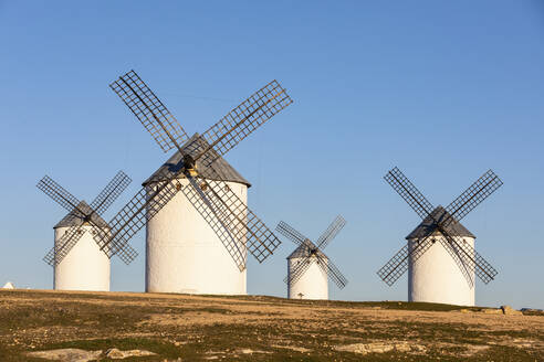 Spain, Province of Ciudad Real, Campo de Criptana, Countryside windmills standing against clear sky - WPEF02123