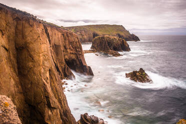 Coastal scenery with Enys Dodnan rock formation at Lands End, Cornwall, England, United Kingdom, Europe - RHPLF12597