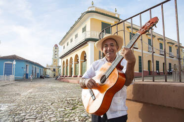 Local man singing and playing his guitar in the Plaza Mayor of Trinidad, UNESCO World Heritage Site, Cuba, West Indies, Caribbean, Central America - RHPLF12632