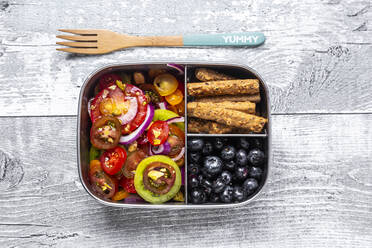 Metal box with tomato salad with red onion and pistachios, blueberries and biscuit sticks, wooden fork - SARF04392