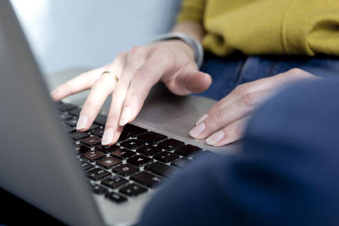 Woman's hand typing on keyboard, close-up - FLLF00327
