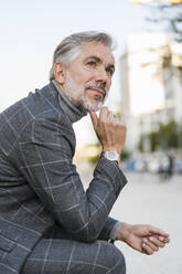 Portrait of fashionable mature businessman in the city - DIGF08625