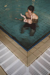 Father with baby in swimming-pool - JOHF04560