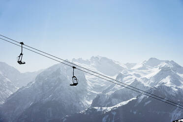 Snow covered mountain landscape with ski lift, Alpe-d'Huez, Rhone-Alpes, France - CUF52645