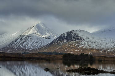 Reflection of snow capped mountains in lake, Scottish Borders, United Kingdom - CUF52660