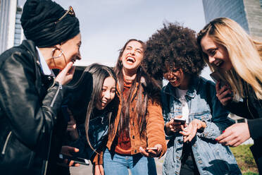 Friends laughing in street, Milan, Italy - CUF52699