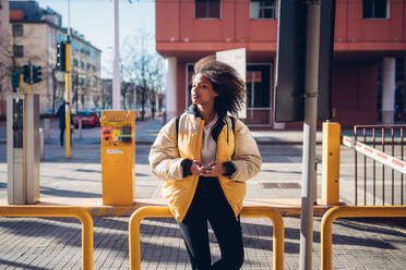 Cool young woman waiting at city tram station - CUF52809