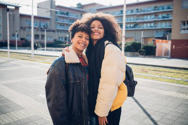 Two young women posing on urban sidewalk, portrait - CUF52813