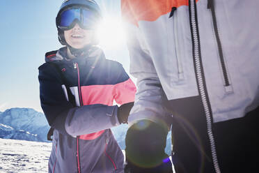 Teenage brother and sister skiers on snow covered mountain top, close up, Alpe-d'Huez, Rhone-Alpes, France - CUF52816