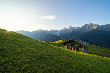 Sonnenaufgang auf Wiesen und Hütte, Tombal, Soglio, Schweiz - CAVF65985