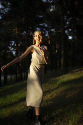 Woman in the forest smiles in motion - CAVF66034