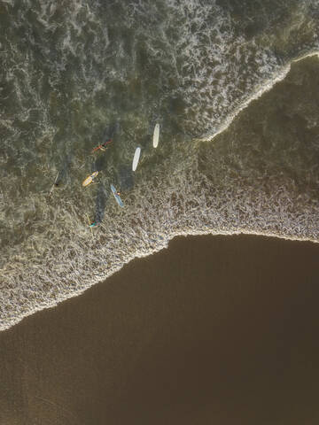 Aerial view of surfers at the beach stock photo