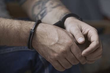 Cropped image of criminal in handcuffs - CAVF66216
