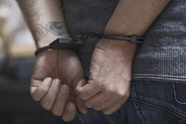 Midsection of criminal in handcuffs - CAVF66217