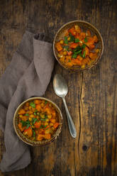 Two bowls of spicy oriental pumpkin stew with chick-peas, parsley and Hokkaido squash - LVF08386