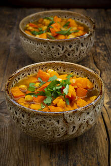 Two bowls of spicy oriental pumpkin stew with chick-peas, parsley and Hokkaido squash - LVF08388