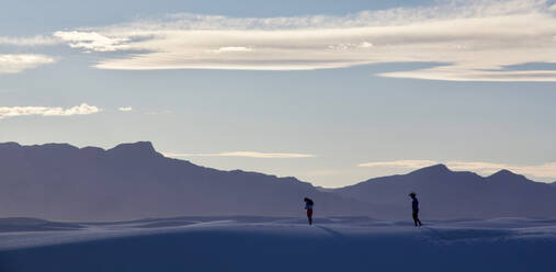 Two silhouettes standing on a sand dune 2 - CAVF66382