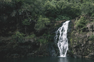 Scenic view of waterfall over rock formations - CAVF66596