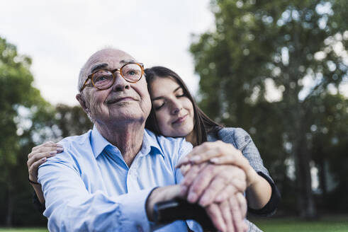 Portrait of senior man with his granddaughter in a park - UUF19337