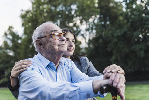 Portrait of senior man man with his granddaughter in a park - UUF19342