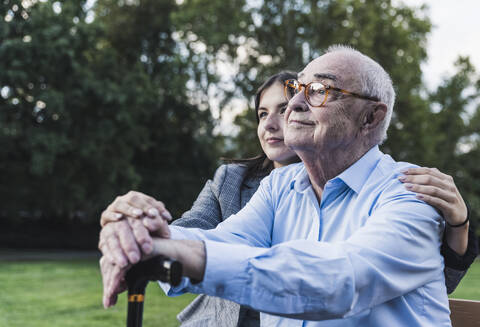 Portrait of senior man with his granddaughter in a park stock photo