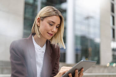 Young businesswoman using tablet in the city - DIGF08700