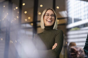 Portrait of happy young woman in the city - DIGF08718