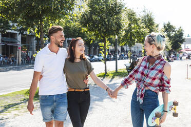 Three friends strolling together having fun - WPEF02212