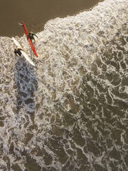 Aerial view of surfers at the beach - CAVF66864