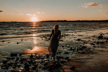 Woman in a dress on a beach - CAVF67004