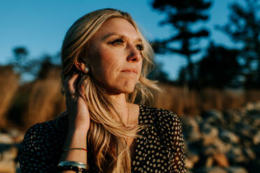 Portrait of hopeful woman looking at the water - CAVF67016