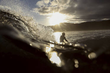 Surfer auf einer Welle bei Sonnenuntergang - CAVF67338